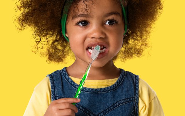 A child brushing their teeth